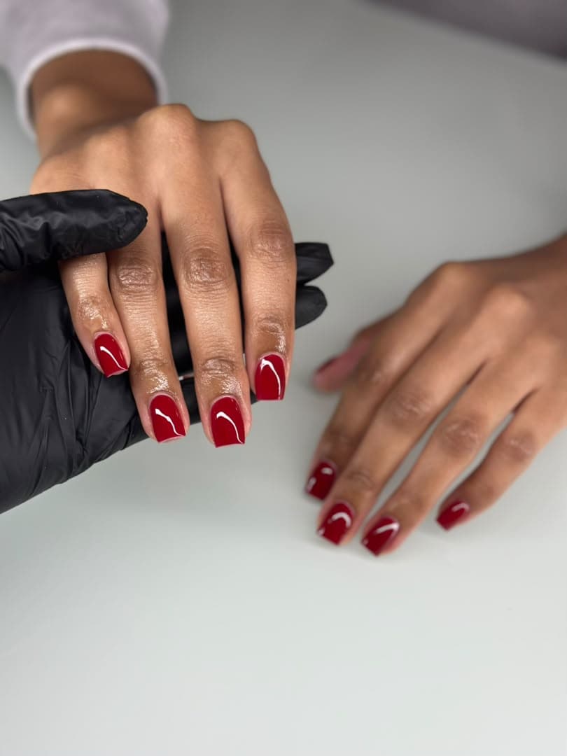 Precision red manicure in progress
